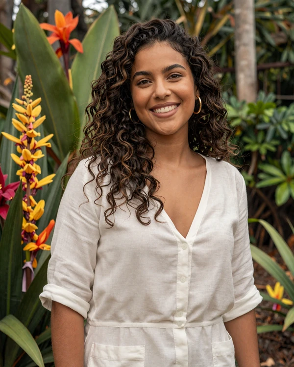 Beautiful Brazilian woman smiling in a tropical garden - authentic Brazilian dating culture and natural warmth