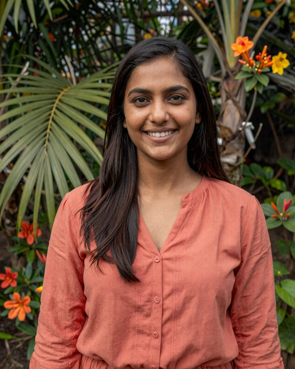 Indo-Surinamese woman smiling in a tropical garden in Paramaribo - authentic Surinamese beauty and multicultural dating culture
