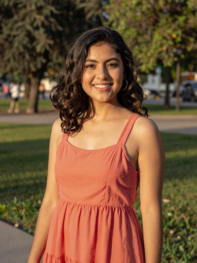 Daniela, 24, Mexican single from Mexico City in a coral sundress at a park