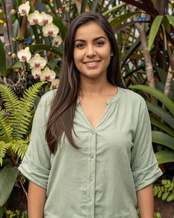 Beautiful Costa Rican woman smiling in a tropical garden - authentic Tica warmth and natural Pura Vida spirit